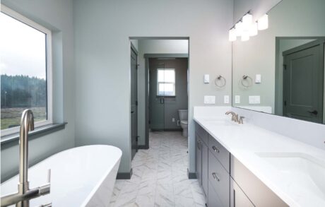 Aspen Custom Home Bathroom 1 Modern bathroom with white bathtub and vanity