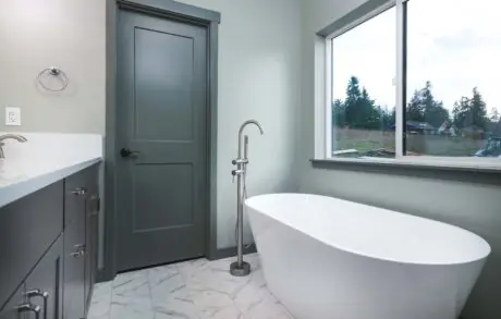 Aspen Custom Home Bathroom 3 - Inspire Homes Modern bathroom with freestanding bathtub and window