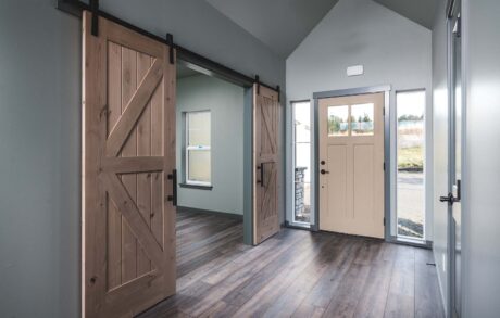 Aspen Custom Home Entry Modern entryway with sliding barn doors design.