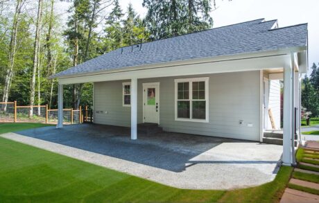 Custom Home Walden_Loop – Back Cozy backyard house with covered patio area.