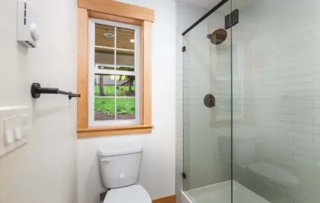 Custom Home Walden_Loop – Bathroom 2 - Inspire Homes Modern bathroom with glass shower and window.