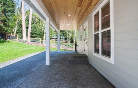 Custom Home Walden_Loop – Patio Covered patio area with wooden ceiling design.