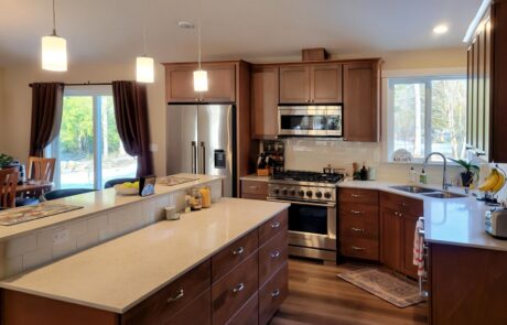 Aspen – Kitchen Modern kitchen with wooden cabinets and island - Tacoma Home Builder - Aspen Home Plan