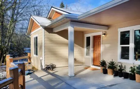 Homan – Front Porch - Inspire Homes Cozy house entrance with potted plants. - Tacoma Home Builder - Aspen Home Plan