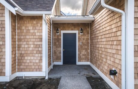 Gallery_0000s_0018_Fidalgo Villas 2_Entry Entrance with wooden siding and dark door.