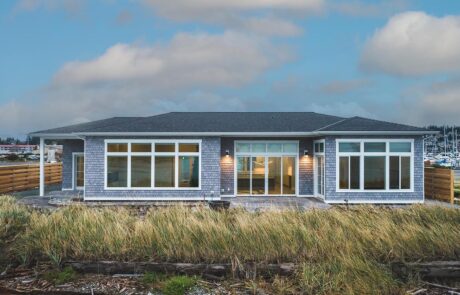 Gallery_0000s_0027_Inspire Homes – Anacortes – Fidalgo Villas – Custom Waterfront Home – Back View Modern seaside bungalow with large glass windows