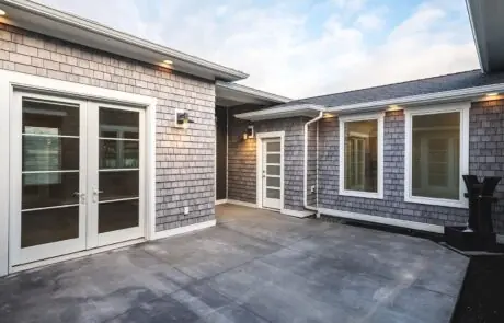 Gallery_0000s_0036_Inspire Homes – Anacortes – Fidalgo Villas – Custom Home – Courtyard - Inspire Homes Modern house exterior with patio and windows