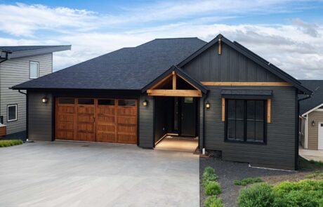 Inspire Homes Juniper Welch Exterior Modern single-story house with wooden garage door