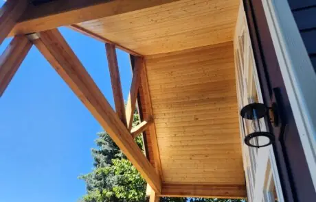 Inspire White Oak Porch Cover - Inspire Homes Wooden porch ceiling against a clear sky