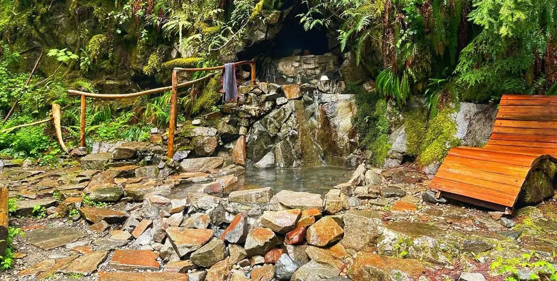 Tranquil natural stone hot spring and greenery