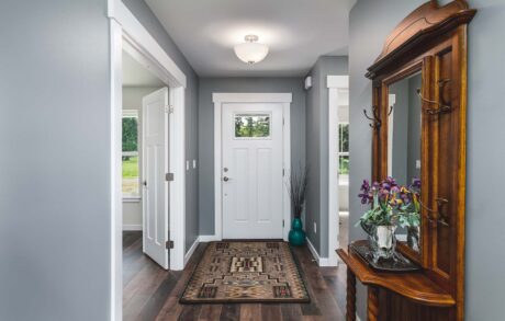 Madrona Custom Home Entry Modern home entryway with wooden furniture decor.