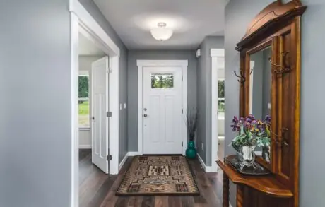 Madrona Custom Home Entry - Inspire Homes Modern home entryway with wooden furniture decor.