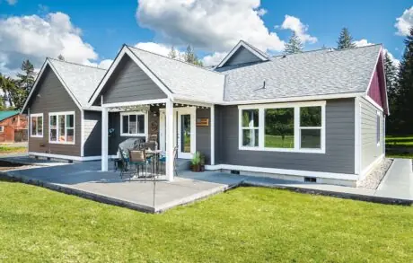 Madrona Custom Home Font - Inspire Homes Modern single-story house with a spacious lawn