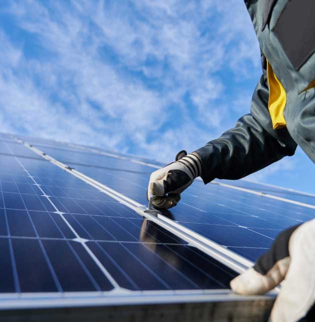 man installing solar panels for net zero homes