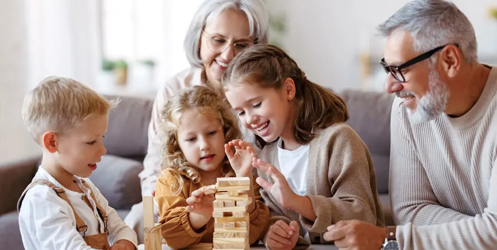 Plan for the future ADU - Inspire Homes Family playing a wooden block stacking game.