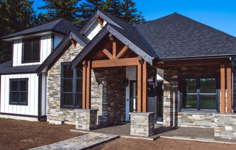 Redwood Custom Front 2 Modern house with stone and wooden exterior design.
