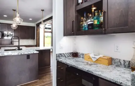 Redwood Custom Kitchen Bar - Inspire Homes Modern kitchen with marble countertops and cabinets