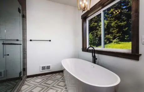 Redwood Custom Master Bath 2 - Inspire Homes Modern bathroom with freestanding tub and window