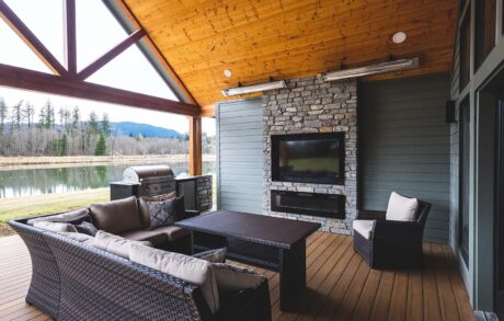 Redwood Timberframe Back Porch Covered outdoor patio with modern seating and fireplace.