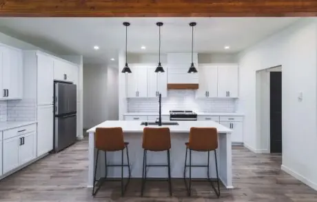 Redwood Timberframe Kitchen - Inspire Homes Modern kitchen interior with white cabinets and island