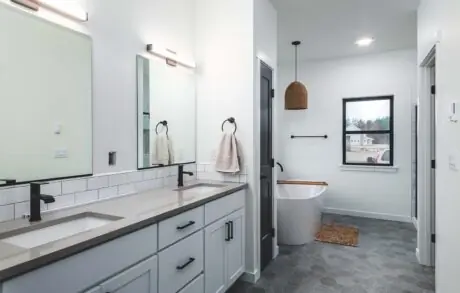 Redwood Timberframe Master Bath - Inspire Homes Modern bathroom with double vanity and bathtub