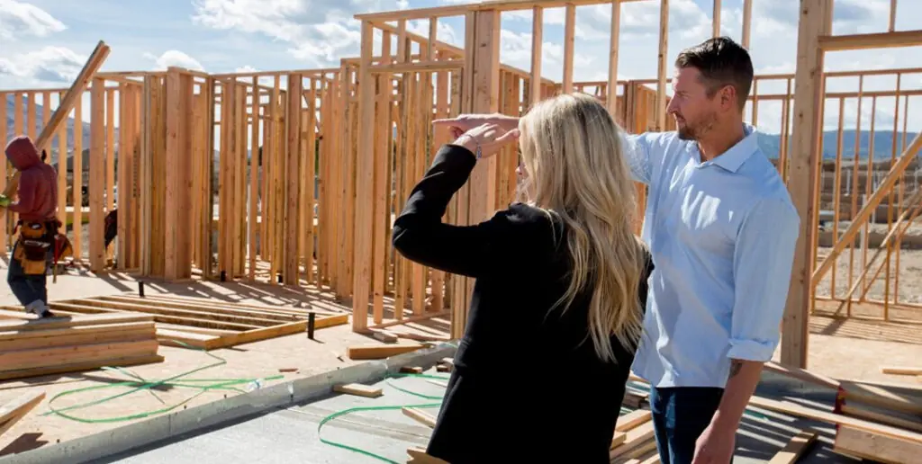 Stay involved - Inspire Homes People discussing construction progress at building site